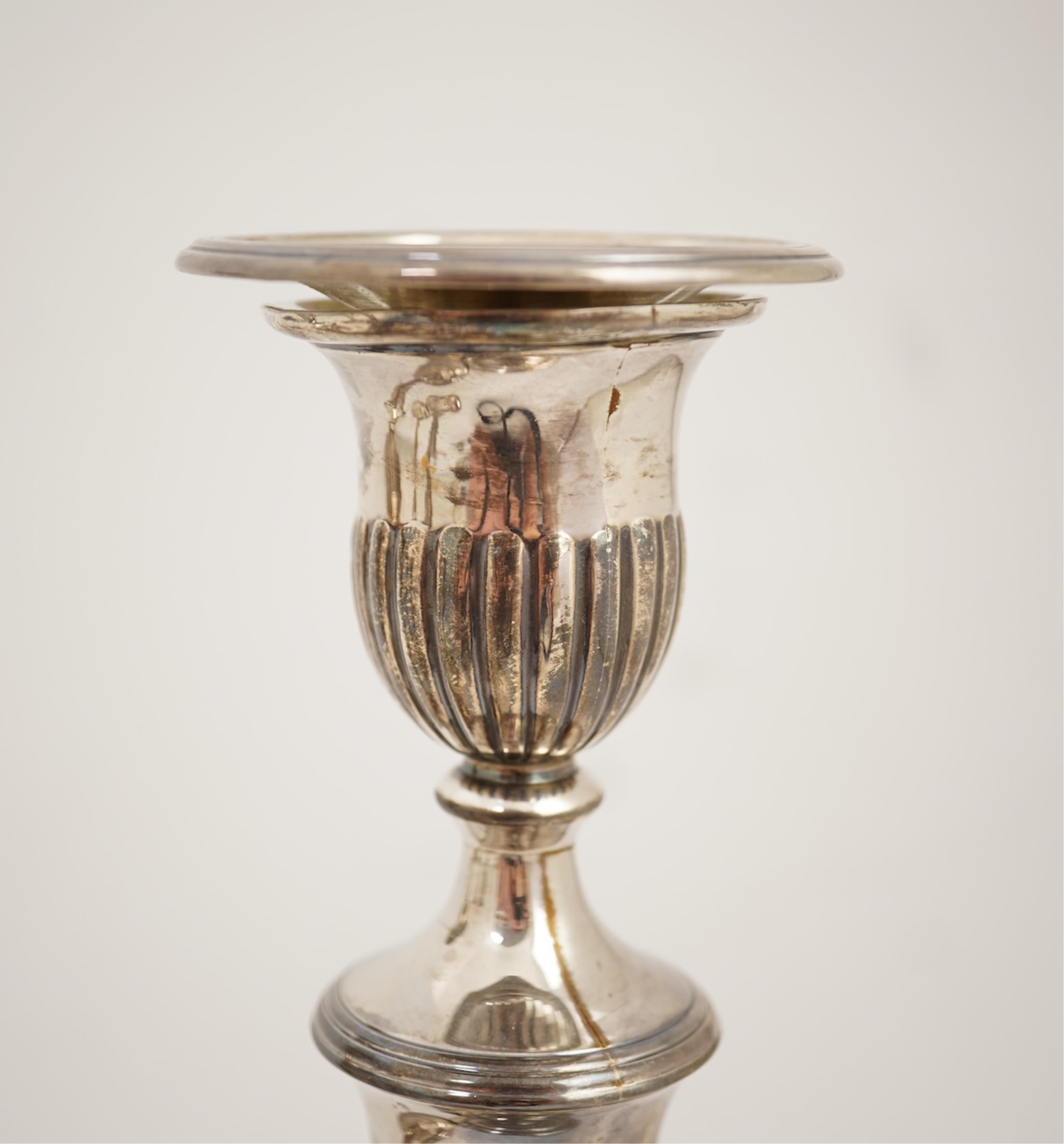A set of four George III silver candlesticks by John Green, Roberts, Mosley & Co, with waisted turned stems, on circular foot, Sheffield, 1801, (repair), 27.5cm, loaded.